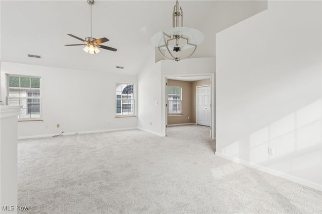 living room with light carpet, a healthy amount of sunlight, and baseboards | Image 13