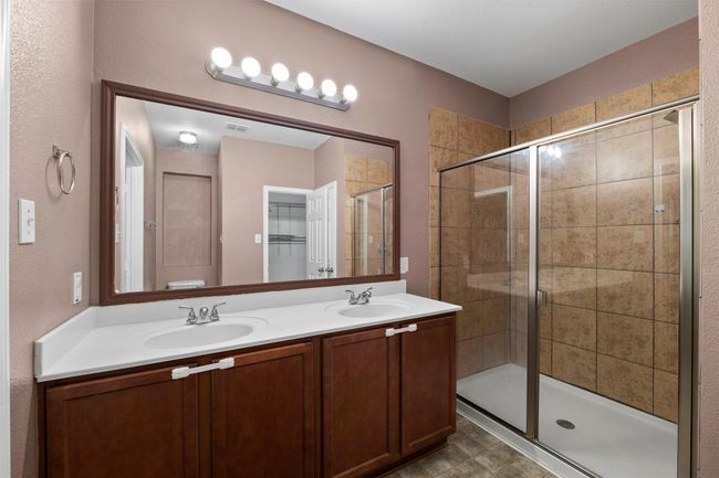 Full bathroom with a sink, visible vents, double vanity, and a stall shower | Image 8