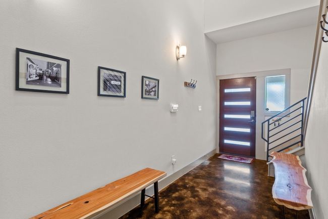 Entryway with stairs, finished concrete flooring, and baseboards | Image 14