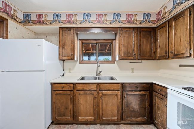 Kitchen featuring white appliances and light countertops | Image 14