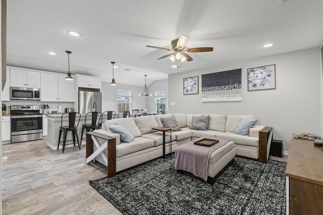 Living area featuring a ceiling fan, recessed lighting, light wood finished floors, and baseboards | Image 8