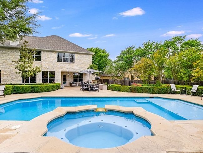 View of pool featuring a pool with connected hot tub, fence, and a patio area | Image 21