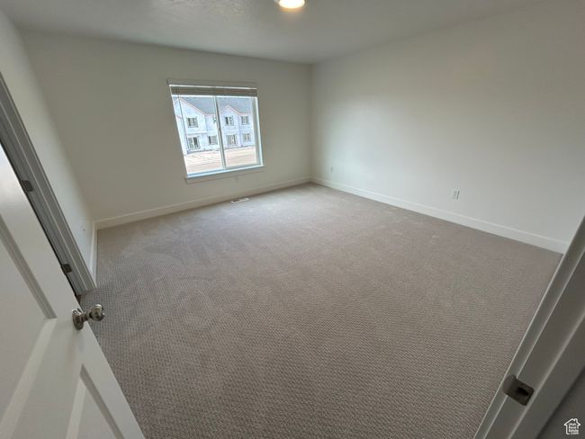 Carpeted empty room featuring baseboards | Image 7