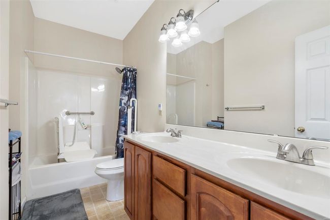 Laundry area with washer and dryer, visible vents, laundry area, and baseboards | Image 9
