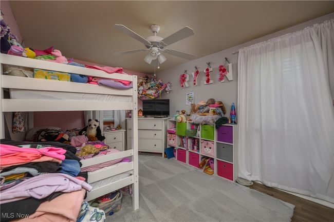 Bedroom featuring a ceiling fan | Image 13