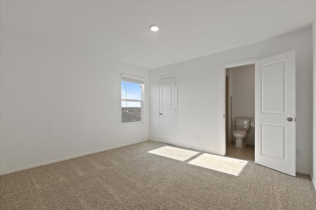 Unfurnished bedroom with light colored carpet and baseboards | Image 15