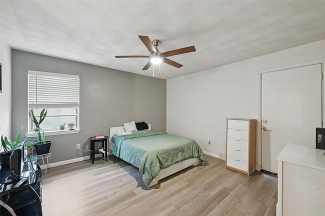 Bedroom featuring light wood finished floors, baseboards, and ceiling fan | Image 24