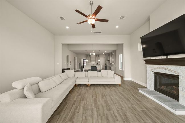Neutral tones and an open layout offer a relaxing environment with easy access to the kitchen and outdoor space. | Image 14