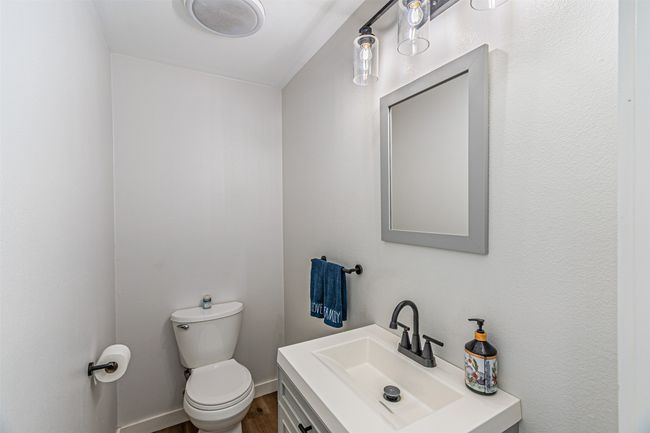 Half bathroom featuring vanity and wood finished floors | Image 18