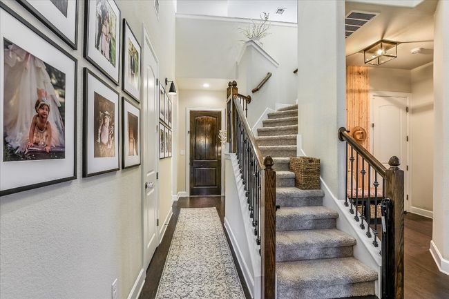 Stairs featuring visible vents, baseboards, and wood finished floors | Image 5