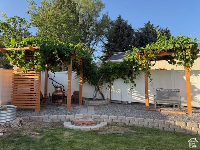 Rear view of house featuring a fenced backyard and a patio area | Image 39