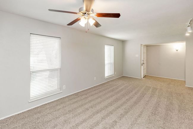 Empty room featuring light colored carpet and ceiling fan | Image 6