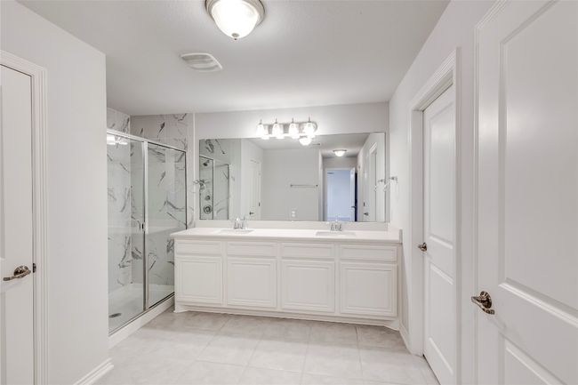 Full bathroom with a marble finish shower and double vanity | Image 24