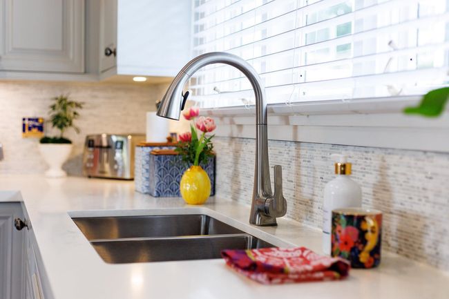 Details with a sink, backsplash, and light countertops | Image 12