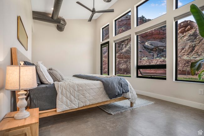 Bedroom with finished concrete flooring and baseboards | Image 23
