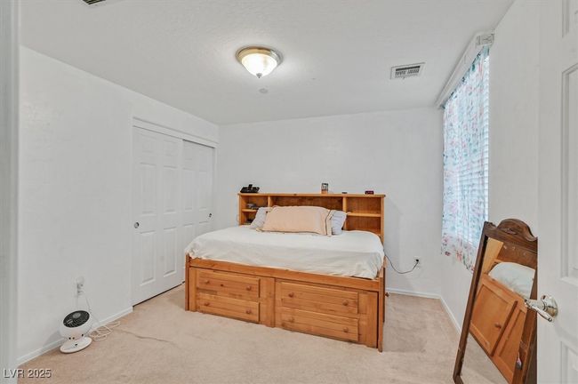 Bedroom with light colored carpet and a closet | Image 14