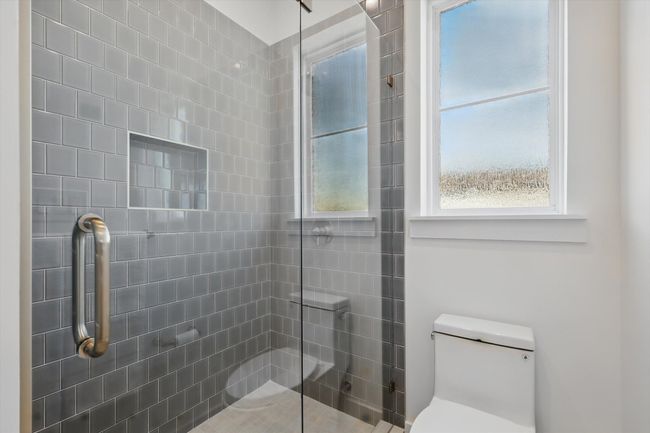 Full bathroom with toilet and tiled shower | Image 15
