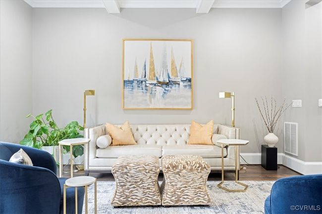 Living area with beamed ceiling, wood finished floors, visible vents, and baseboards | Image 11