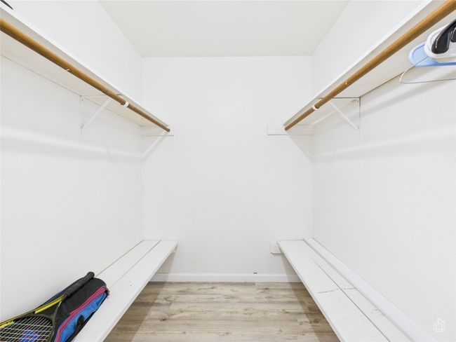 Large spacious closet featuring wood finished floors | Image 16