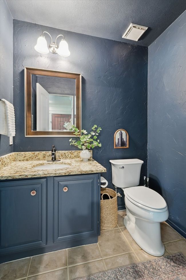Half bath with vanity, tile patterned floors, a textured ceiling, and a textured wall | Image 15