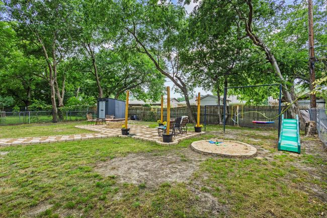View of yard with a storage unit, a patio area, and an outdoor structure | Image 37