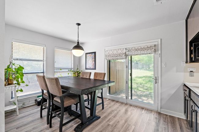Dining room with light wood-style flooring and baseboards | Image 12