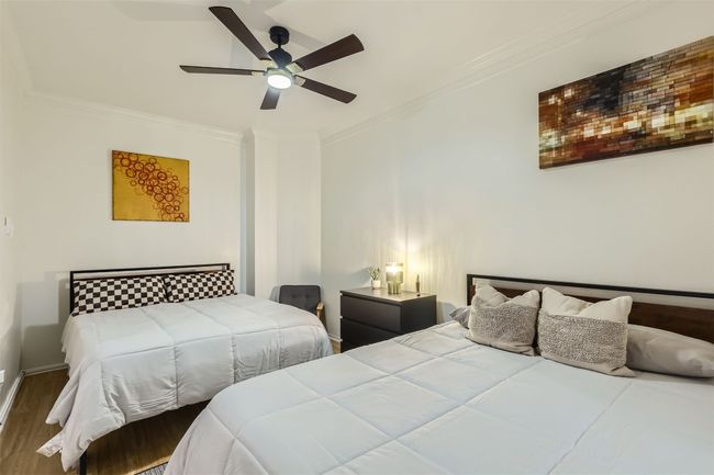 Bedroom featuring ornamental molding, wood finished floors, and ceiling fan | Image 13