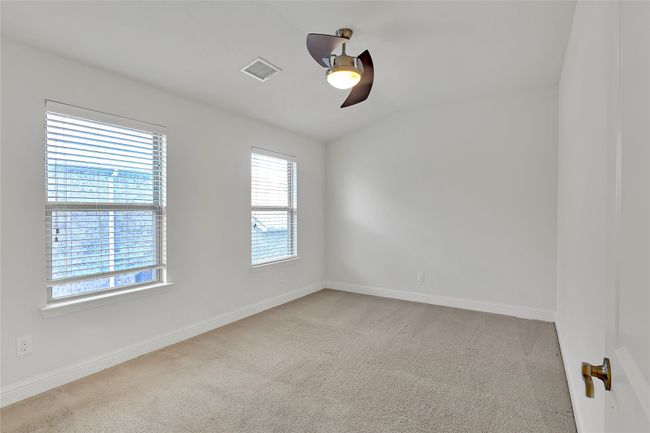 Spare room with a ceiling fan, healthy amount of natural light, carpet flooring, and vaulted ceiling | Image 19