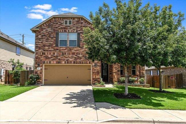 View of front of property featuring a garage, brick siding, and driveway | Image 35