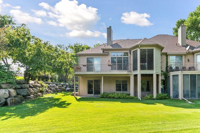 Private backyard sanctuary framed by mature hostas. | Image 53