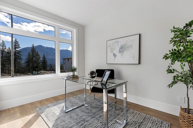 Office area with a mountain view, baseboards, and wood finished floors | Image 17