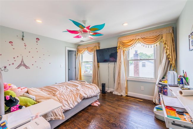 Bedroom with wood finished floors, baseboards, recessed lighting, and ceiling fan | Image 11