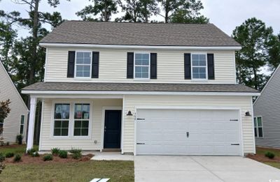 View of front facade with a garage | Image 1