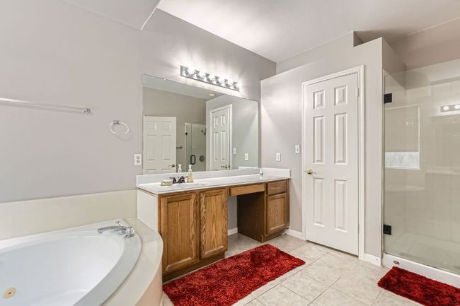 Bathroom with a shower stall, double vanity, a whirlpool tub, and tile patterned flooring | Image 17