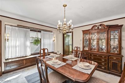 Carpeted dining space featuring a chandelier | Image 3