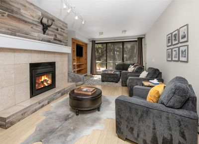 Living room featuring hardwood / wood-style floors and a tile fireplace | Image 2