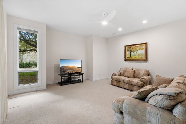 Lower-level living room with access to the back patio. | Image 24
