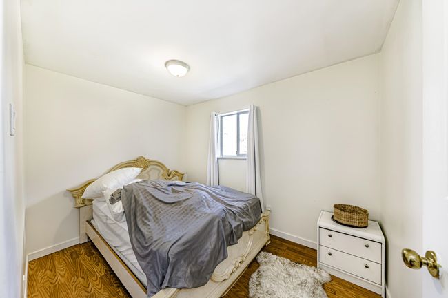Bedroom featuring baseboards and wood finished floors | Image 13