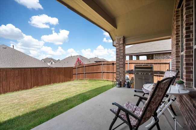 Fenced backyard featuring a patio area and a grill | Image 26