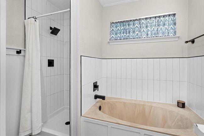 Primary bath was updated with new tile surround and fixtures. In addition to the soaking tub there is also a separate shower. | Image 19