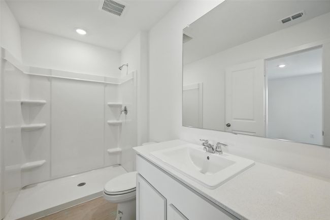 Full bath with a stall shower, vanity, recessed lighting, and wood finished floors | Image 17
