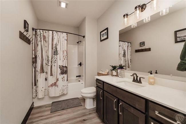 Hall bathroom with lot of cabinet storage, bath/shower combo. | Image 12
