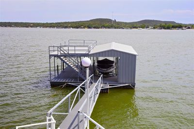 Dock area featuring a water and mountain view | Image 2