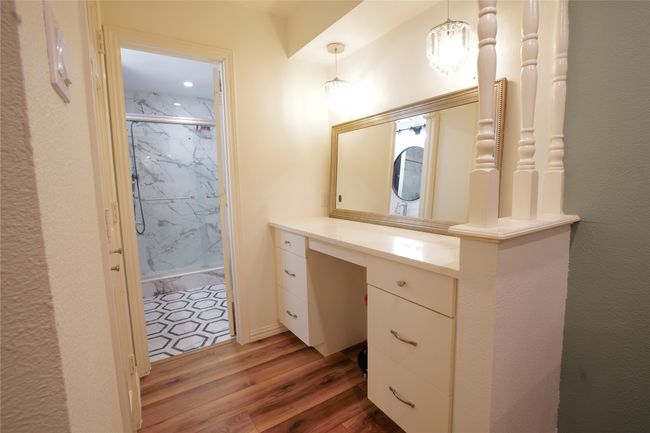 Bathroom featuring wood finished floors, a marble finish shower, and vanity | Image 18