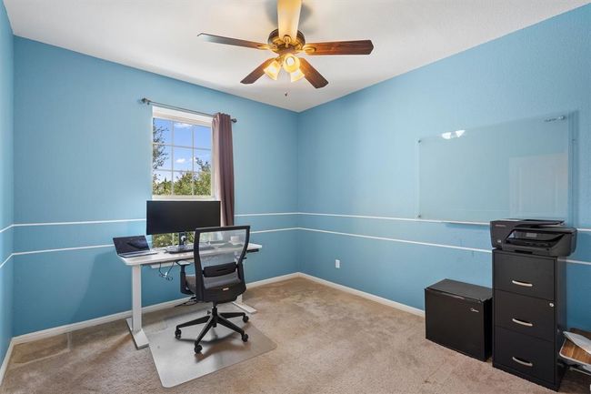 Office area featuring carpet, a ceiling fan, and baseboards | Image 30