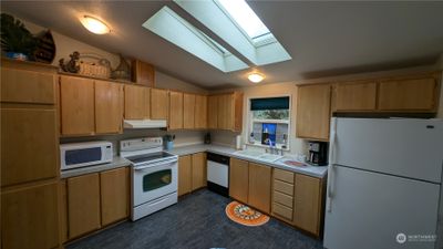 Light filled eat-in kitchen with skylights. | Image 3