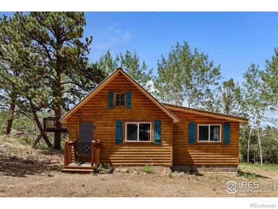 A solid cabin nestled in the wood | Image 2