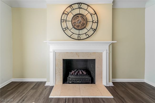 Details with baseboards, a fireplace, and wood finished floors | Image 10
