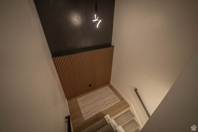 Head down to the basement and be wowed by soaring 13-foot ceilings, a stunning natural oak slat accent wall, and a bold, moody feature wall above. The modern hanging light adds the perfect contemporary touch. You won’t find this kind of unique design in | Image 29