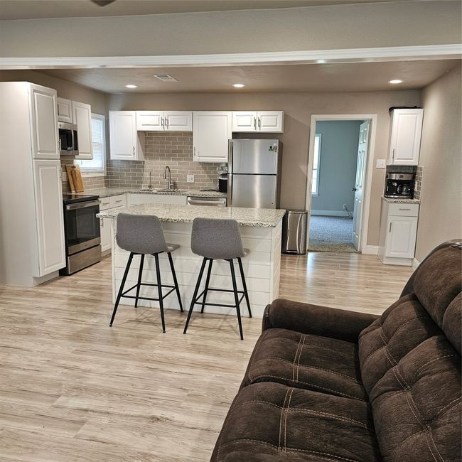 Spacious open concept kitchen and living room. | Image 5